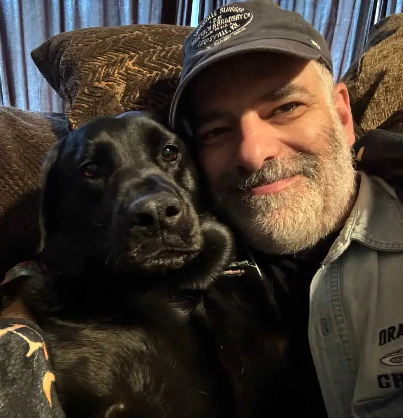 Dr. Michael D. Sturt, smiling with his dog at McHenry Smile Center.