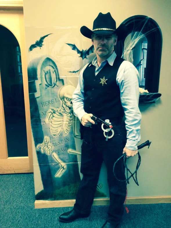 Dr. Michael D. Sturt dresssed as a gunslinger for Halloween at McHenry Smile Center.